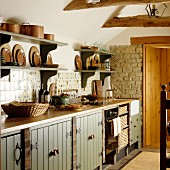 Wall-mounted shelves above kitchen counter with base units in rustic kitchen