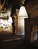 Former factory hall with large, white pendant lamp