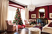 Grand living room with bay window and Christmas tree decorated in red and white