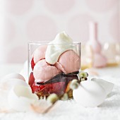 Fruit ice cream on marinated plums with vanilla pods and cream for Easter