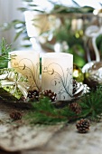 Festive atmosphere with ornate candles and small fir cones in dish