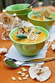Cream of squash soup with apple crisps and pumpkin seeds
