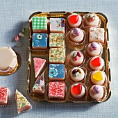 Colourful petits fours on a gold tray