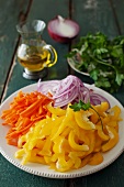 Sliced Yellow Pepper, Carrots and Red Onion on a White Plate