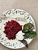 Beetroot risotto served with a blob of herb ricotta