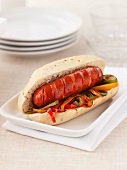 Hot dog with sliced vegetables and cheese