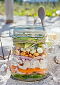 Ingredients for making ceviche, layered in a jar