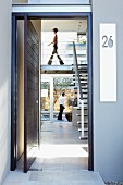 View of staircase and gallery through open front door