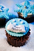Chocolate Winter Cupcakes with Happy Holidays Decoration and Blue Snowflakes