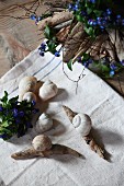 Creative decor idea - stylised snails made from driftwood and snails' shells and arrangements of forget-me-nots