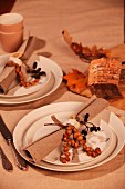 Place setting with linen napkin and autumnal decorations
