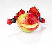 A smiling apple with berries