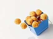 Breaded chicken nuggets with dip in a takeaway box