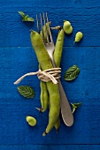 Broad beans, a fork and mint