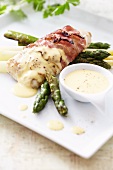 Hake wrapped in bacon with asparagus and hollandaise sauce