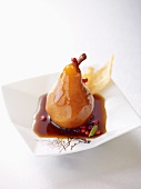 A poached pear in coffee syrup