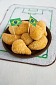 Salgadinhos (filled pastries, Brazil) with football-themed decoration