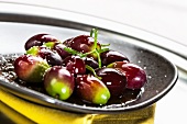 Green and red olives on a plate