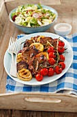 Grilled pork collar steaks with grilled vegetables and salad