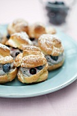 A plate of profiteroles filled with blueberries and quark
