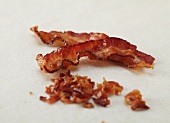 Two Crispy Strips of Bacon with Crumbled Bacon