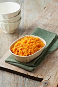 Carrot and swede crush in a white dish on green napkin