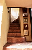 Photo gallery on the wall next to a stairway in an Ecuadorian manor house