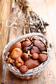 Fresh mushrooms in a basket on a wooden table