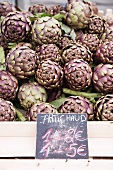 Artichokes at the market with price label