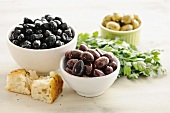 Kalamata olives in bowls, with bread and parsley