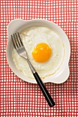A fried egg with a fork