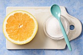 Half a grapefruit with sugar and a plastic spoon
