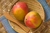 Two mangos in a basket