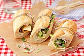 Baguette sandwich filled with cheese, ham and vegetables