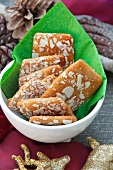 Spiced gingerbread biscuits with almonds, in a bowl