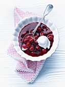 Chilled sour cherry soup with a blob of cream