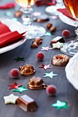 Miniature cake moulds used as table scatter decorations on table set for Christmas dinner