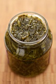 Pickled spinach in a screw-top jar