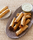 Beef Taquitos on a Platter with Dipping Sauce