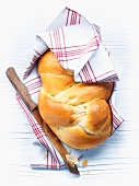 Hefezopf (sweet bread from southern Germany) wrapped in a tea towel