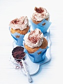 Muffins with cream and cocoa powder