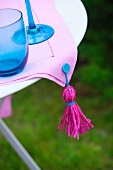 Tablecloth with homemade tassel on a patio table