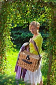 Lady with a picnic basket in the garden