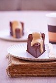 Pieces of double chocolate cake with coffee glaze on paper plates