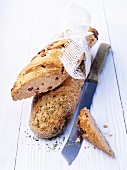 Bacon bread and herb bread with a bread knife