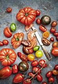 Assorted varieties of tomatoes, whole and sliced