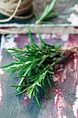 Fresh rosemary on a colorful, wooden surface