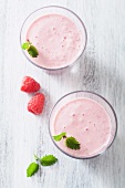 Two raspberry milkshakes with lemon balm (view from above)