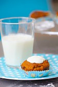 Carrot muffin with glacé icing and a glass of milk