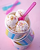 Lemon ice cream with colourful sugar pearls in a cardboard cup